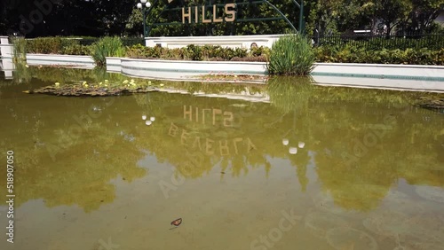 Los Angeles, California, USA, June 21, 2022: TILT SHOT - The Beverly Hills Sign. A 40-foot arched sign is located on Santa Monica Boulevard in Beverly Gardens Park.