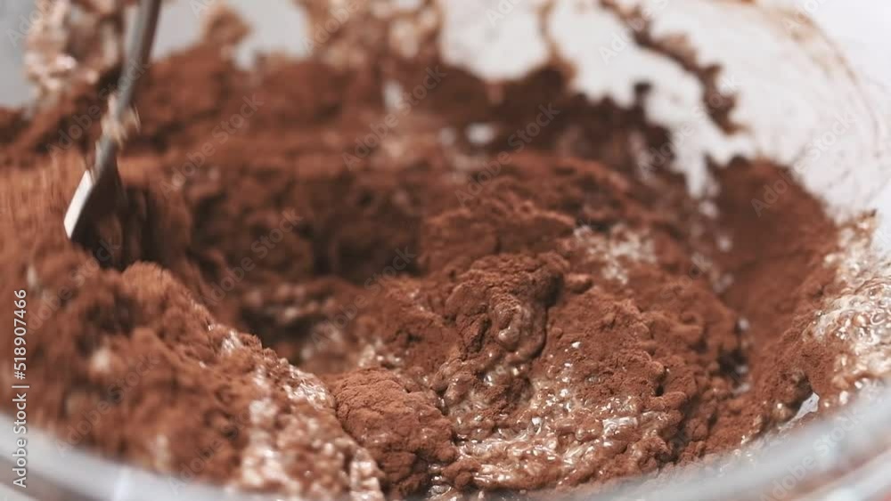 Process of making chia pudding with cocoa. Stirring ingredients in a glass bowl.
Process of making chia pudding with cocoa. Stirring ingredients in a glass bowl.