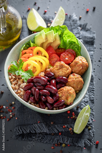 Wholesome Mexican salad with groats, meatballs, limes and vegetables.