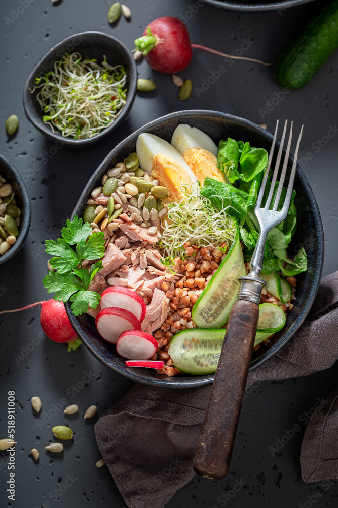 Healthy Nicoise salad with cucumber, tuna and eggs.