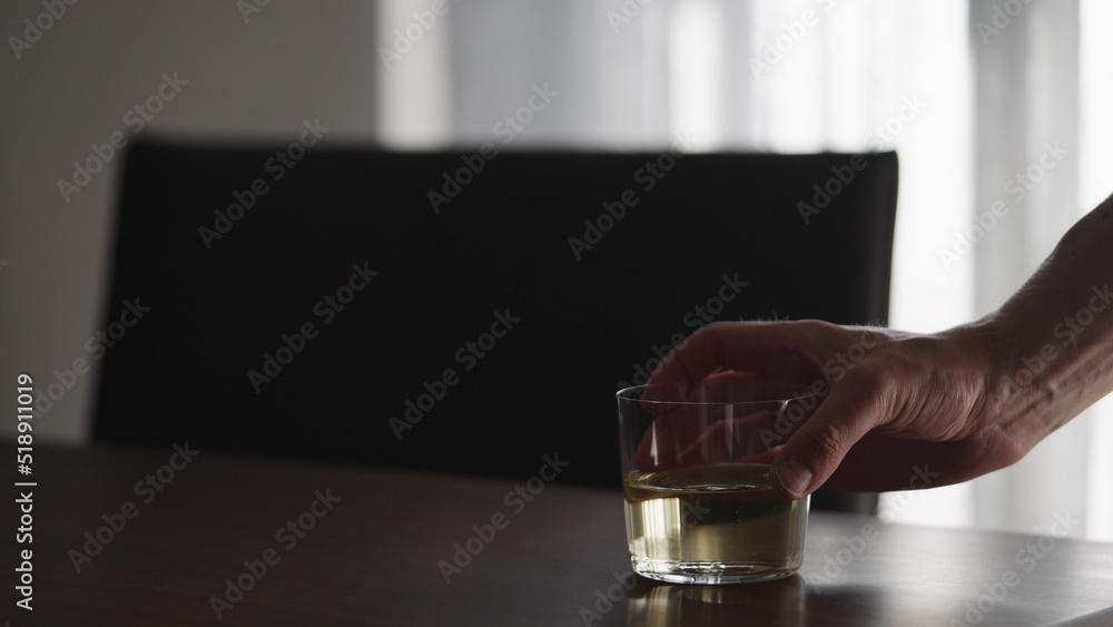 man take white wine in glass from walnut table