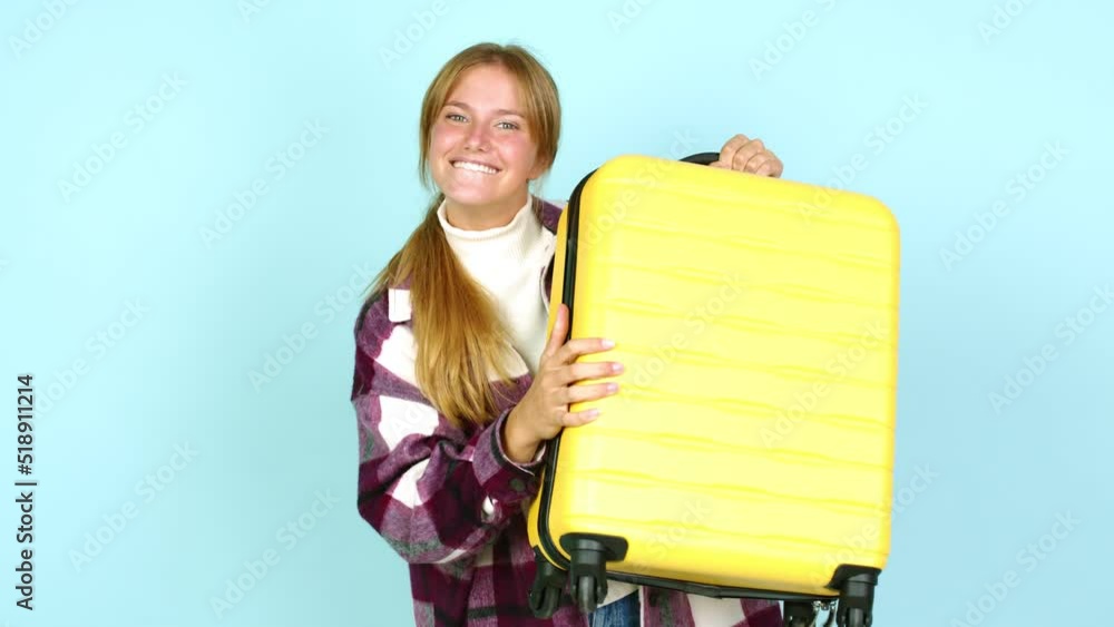 Young pretty blonde woman celebrating a victory and holding a briefcase over isolated background Young pretty blonde woman celebrating a victory and holding a briefcase over isolated background