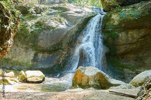 Mountain waterfall in the forest, a large noisy stream of water photo