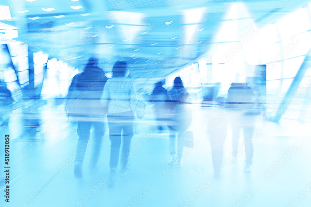 blue background blurred movement of people shopping mall blue background blurred movement of people shopping mall