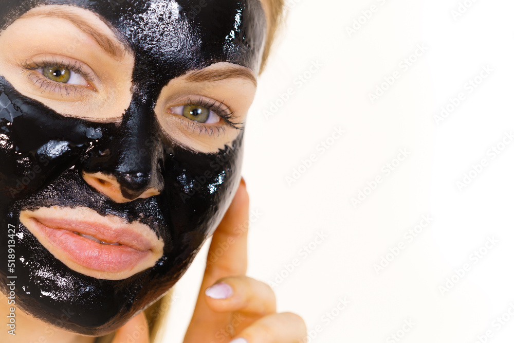 Woman with black peel off mask on face Woman with black peel off mask on face