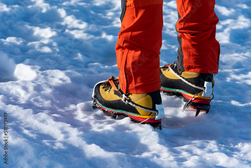 Foto Ice climber wearing crampons in a mountain boots - stock photo