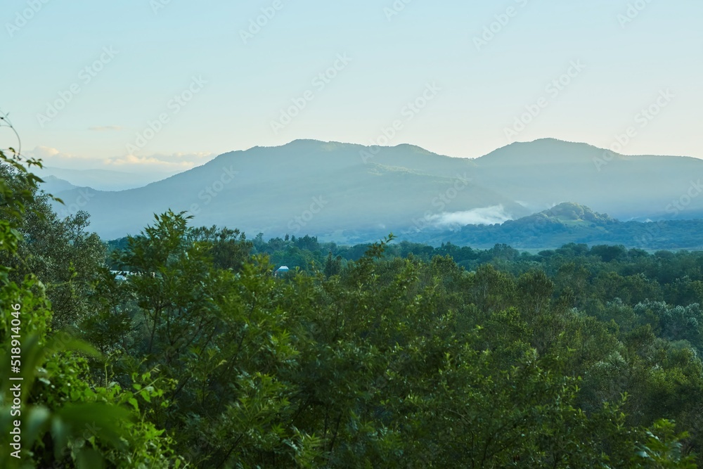 Summer mountain landscape. High mountains and above the mountains a bright blue sky
