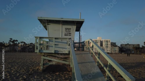Los Angeles, California, USA, June 21, 2022: TILT SHOT - Lifeguard hut or Lifeguard cabin on the sandy beach of Santa Monica. 