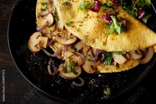 Mushroom omelette on plate on table photo
