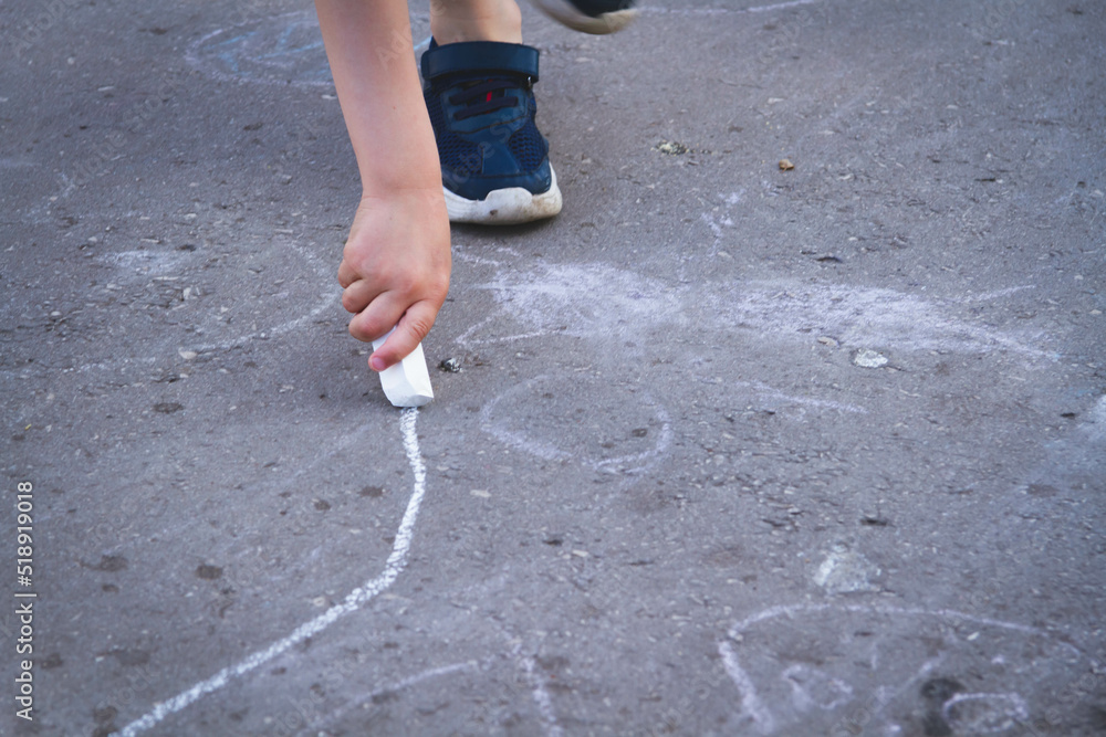Children draw with chalk on the road. Children's creativity on the street. Children draw with chalk on the road. Children's creativity on the street.