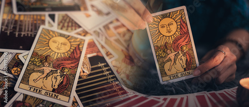 Fotografie, Obraz Fortune teller holding THE SUN card and tarot cards