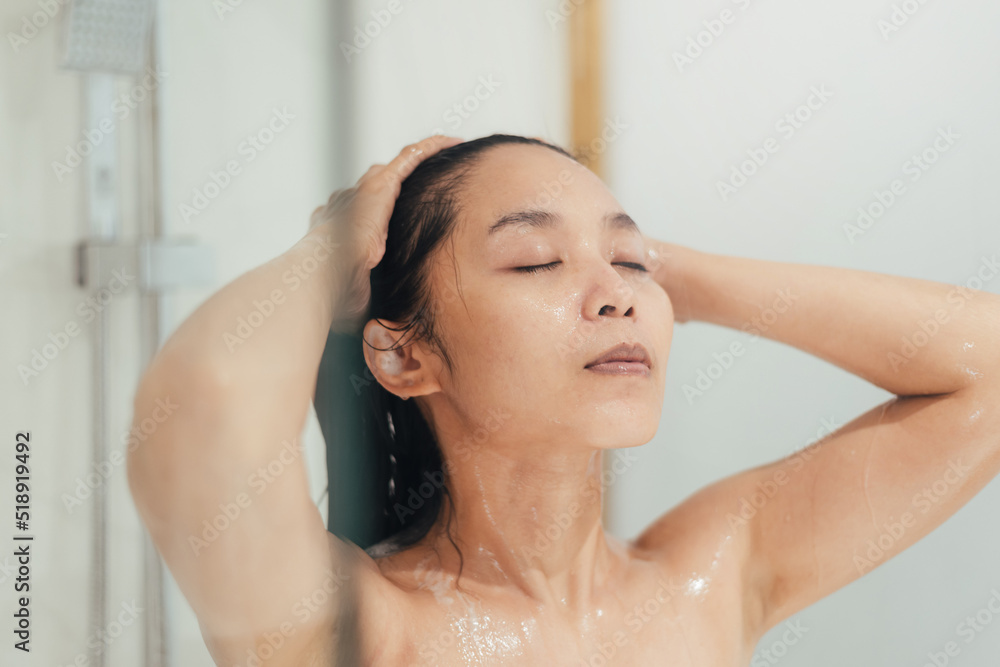 Naklejka premium Woman Washing hair with shampoo and shower in bathroom, Asian female body and hair care with foam to freshness. Spa and Health care.