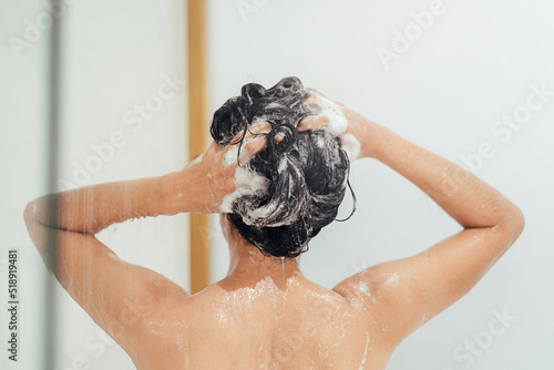 Woman Washing hair with shampoo and shower in bathroom, Asian female body and hair care with foam to freshness. Spa and Health care.