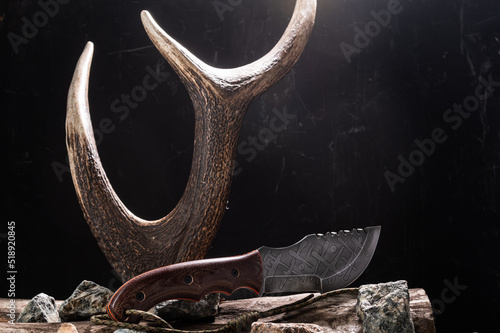 Large hunting knife and antler. Bushcraft knife and deer horn. photo