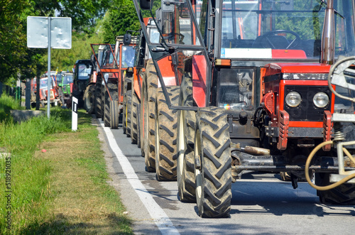 Column of tractors at protests. Farmers at demonstrations. Blocking the road with tractors.