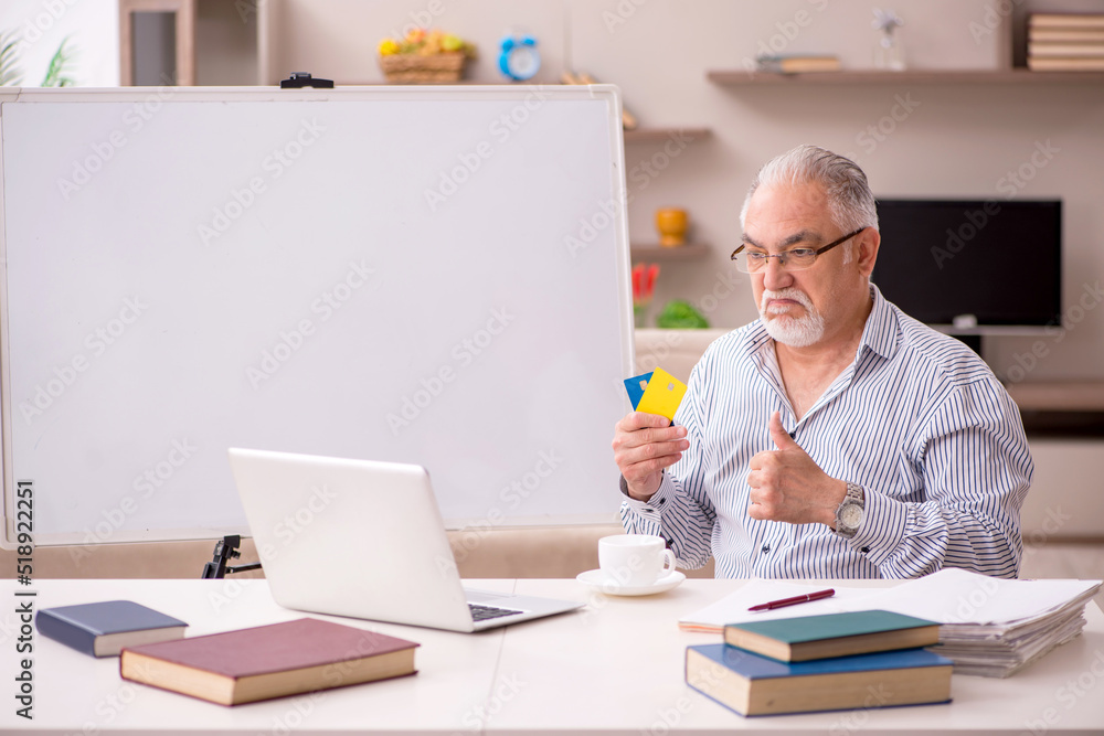Old male employee working from home during pandemic Old male employee working from home during pandemic