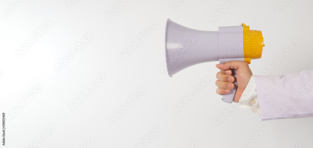 Megaphone in doctor's hand on white background. Studio shooting. Megaphone in doctor's hand on white background. Studio shooting.