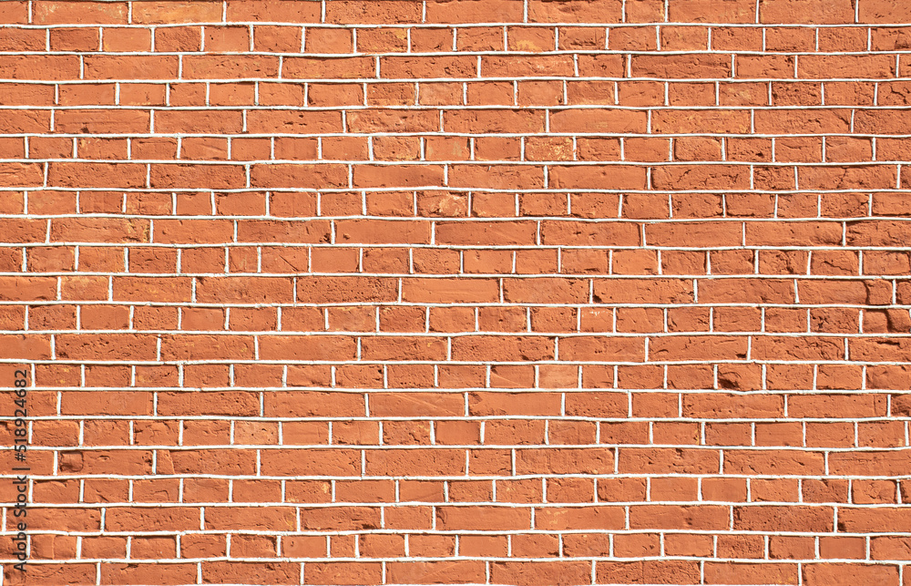 Fototapeta premium red old brick wall with gray cement joints