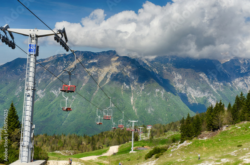 Velika Planina or Big Pasture Plateau in the Kamnik Alps, Slovenia. Mountain cottage hut or house on green hill. Alpine meadow landscape. Cable car