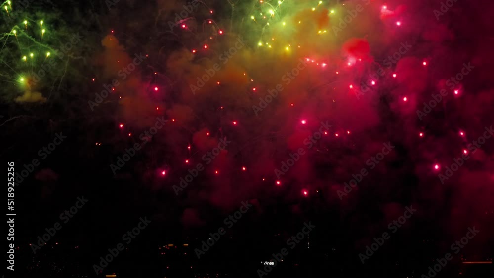 Bright lights of beautiful festive fireworks in the night sky in the city Bright lights of beautiful festive fireworks in the night sky in the city