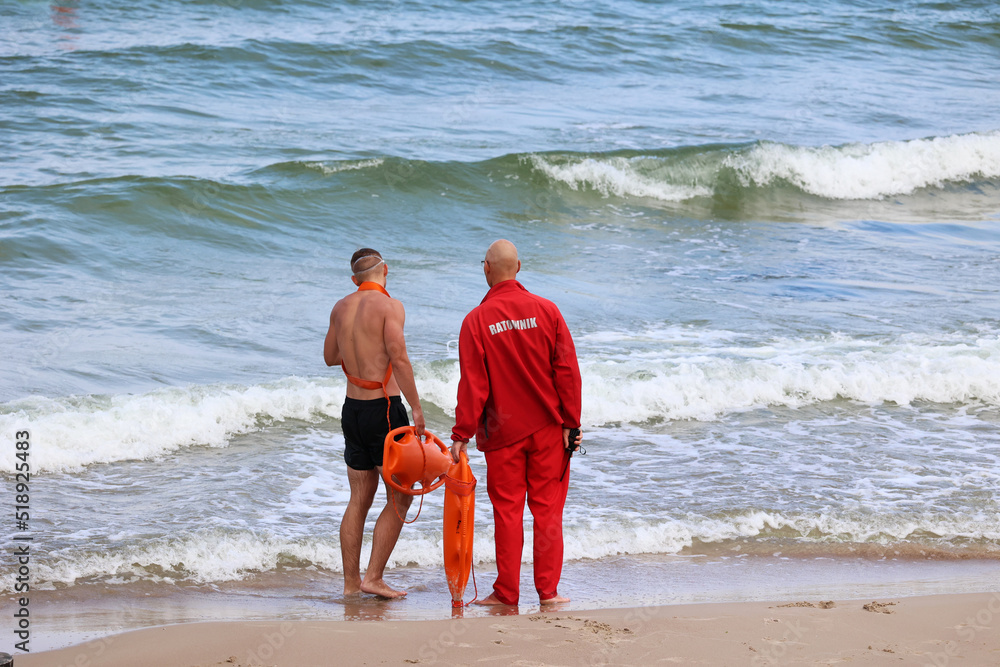 Ratownik na plaży podczas patrolowania brzegu wody. Stock Photo | Adobe ...