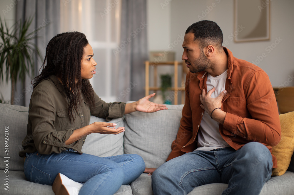 Angry Black Couple Having Quarrel Sitting On Sofa At Home Angry Black Couple Having Quarrel Sitting On Sofa At Home