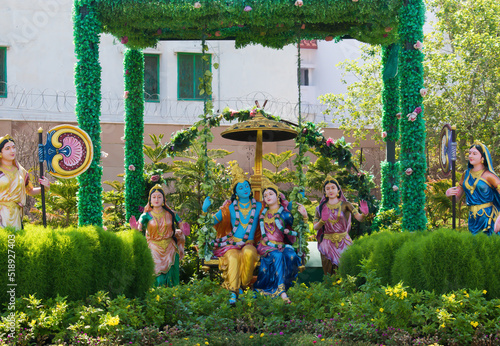 Colorful life size idols of Krishna, Radha sitting and swing at Prem Mandir temple. Happy Krishna Janmashtami.  selective focus on subject.