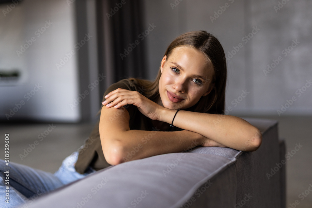 Young woman lying on couch and relaxing at home Young woman lying on couch and relaxing at home