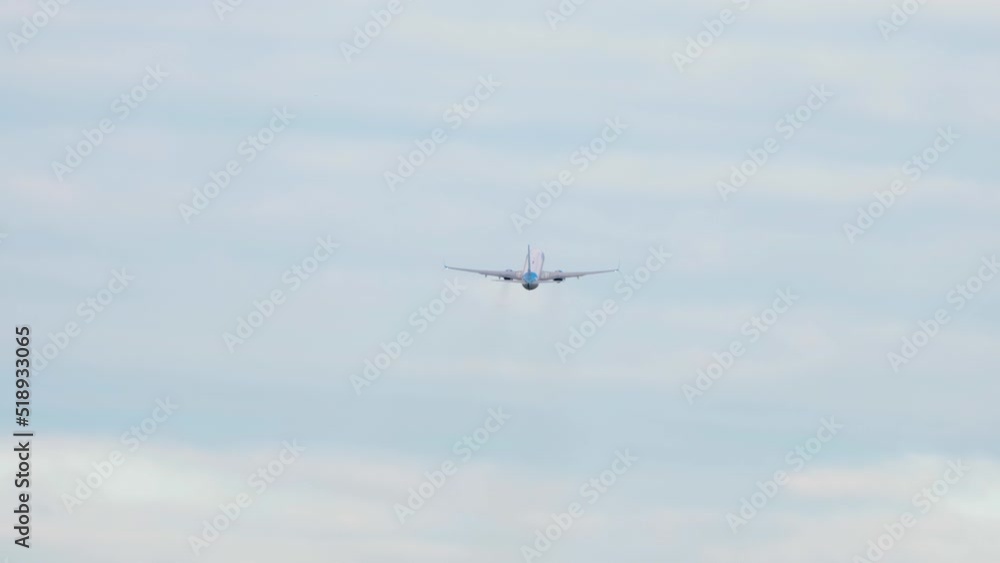 Unrecognizable jet plane climb, long shot rear view. Commercial aircraft flying away. Tourism and travel concept Unrecognizable jet plane climb, long shot rear view. Commercial aircraft flying away. Tourism and travel concept