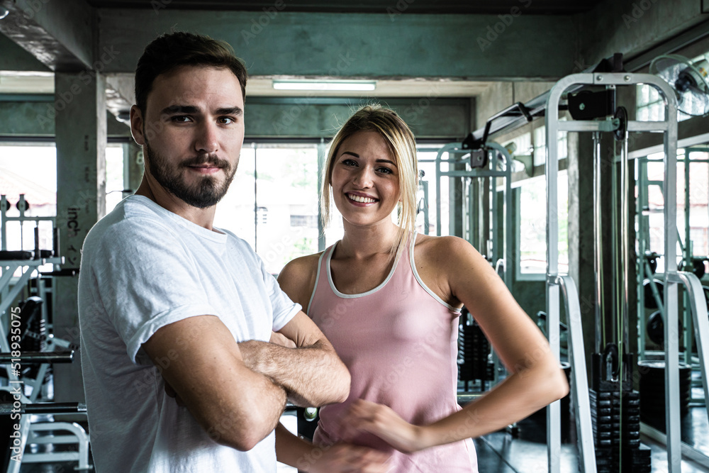 Smart sport man and woman working out in fitness gym Smart sport man and woman working out in fitness gym