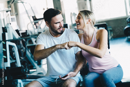 Smart sport man and woman working out in fitness gym