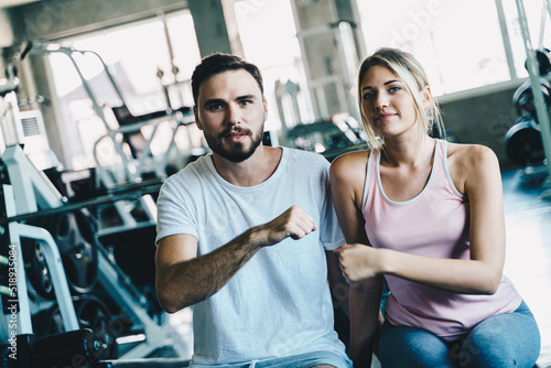 Smart sport man and woman working out in fitness gym