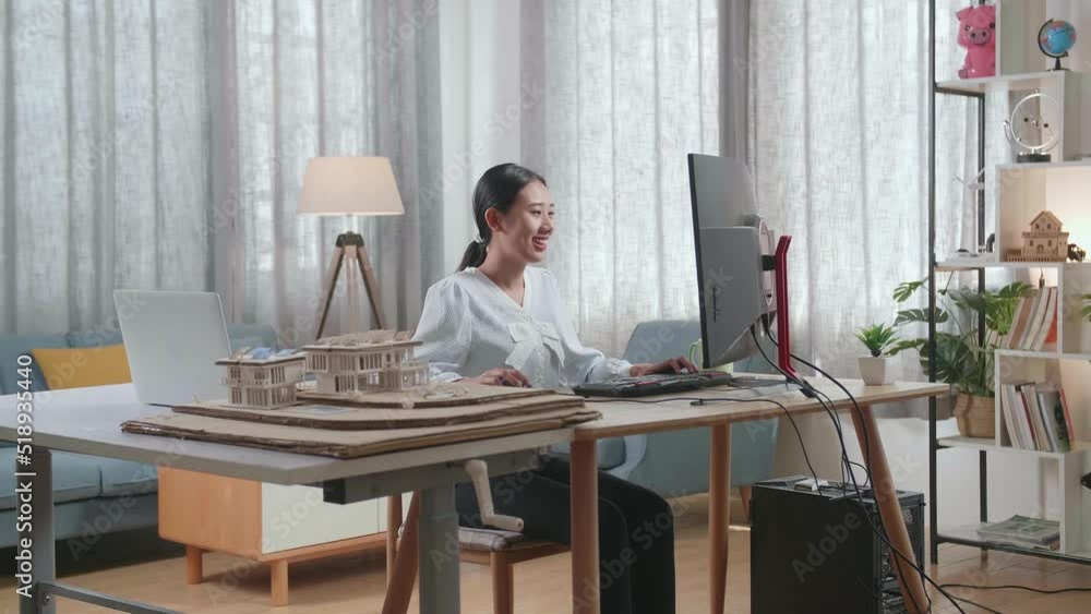 Smiling Asian Woman Engineer With The House Model While Working On A Desktop At Home
Smiling Asian Woman Engineer With The House Model While Working On A Desktop At Home