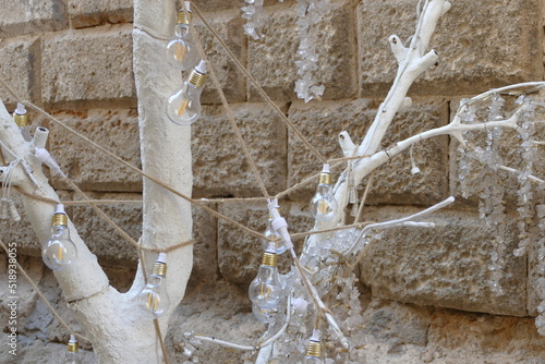 Lampadine appese sui rami di un albero dipinto
