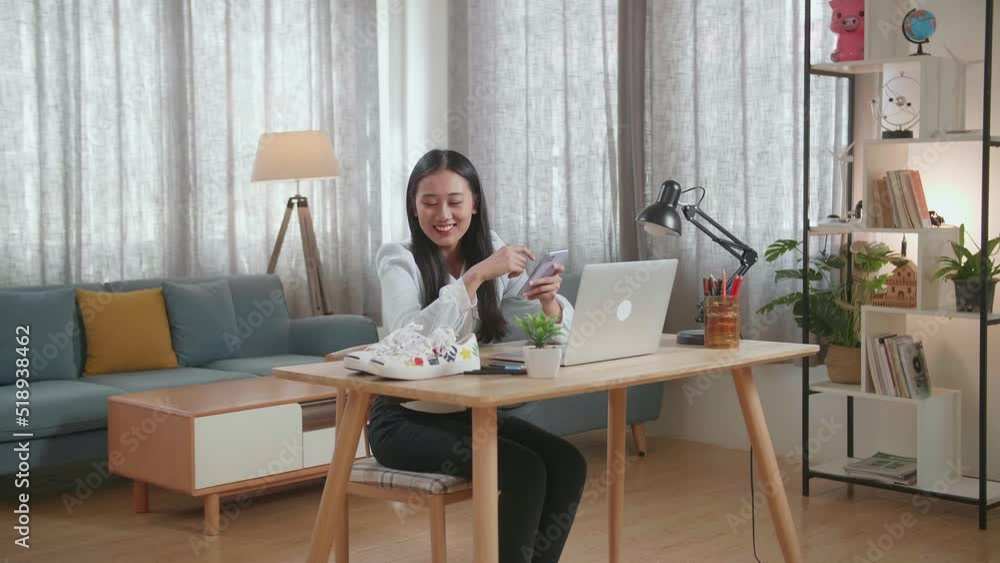 Smiling Asian Female Footwear Designer Looking At The Shoes And Using Smartphone While Working On A Laptop At Home
Smiling Asian Female Footwear Designer Looking At The Shoes And Using Smartphone While Working On A Laptop At Home