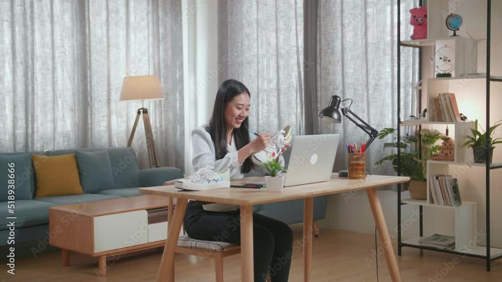 Smiling Asian Female Footwear Designer With A Laptop Holding And Looking At The Colourful Pattern Sneakers
Smiling Asian Female Footwear Designer With A Laptop Holding And Looking At The Colourful Pattern Sneakers