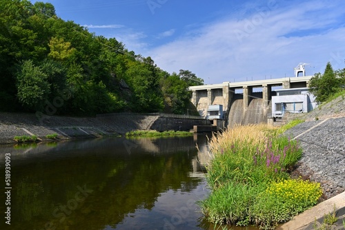 A dam on the Brno Reservoir by the Svratka River with a small power plant. Kninicky hydropower plant. The power plant uses one Kaplan turbine. photo