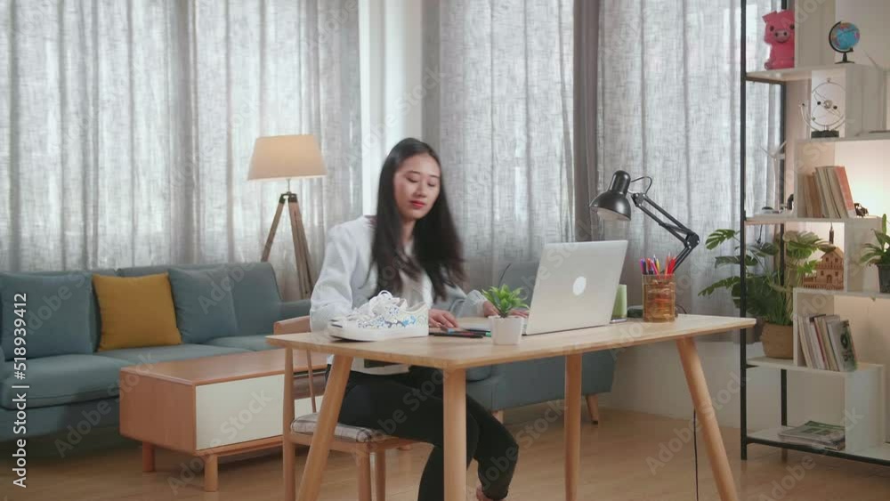 Asian Female Footwear Designer Smiling To The Camera While Working On A Laptop At Home
Asian Female Footwear Designer Smiling To The Camera While Working On A Laptop At Home