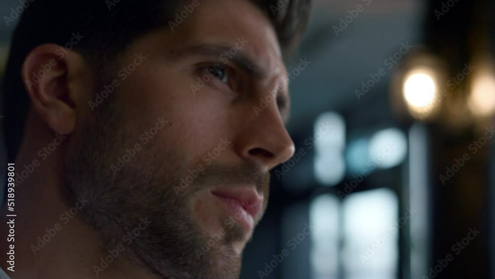 Closeup thoughtful man looking aside making decision in dark restaurant interior Closeup thoughtful man looking aside making decision in dark restaurant interior