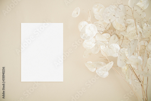 Elegant invitation card mockup with lunaria leaves on beige background
 photo