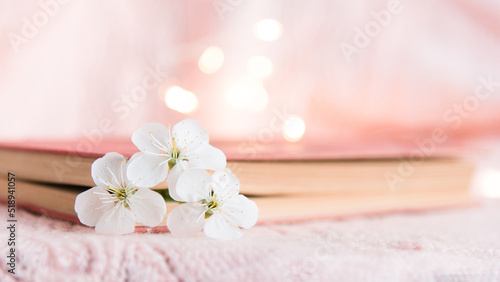 old book with white small flowers on a pink background 
