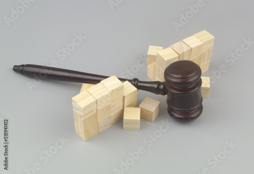 Wooden gavel breaking wall. Laws and freedom concept.	
