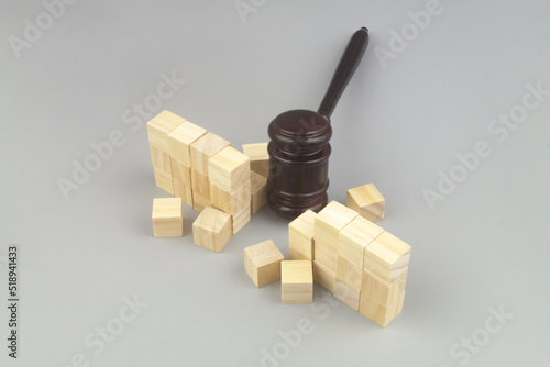 Wooden judge gavel breaking bricks wall. Freedom concept.