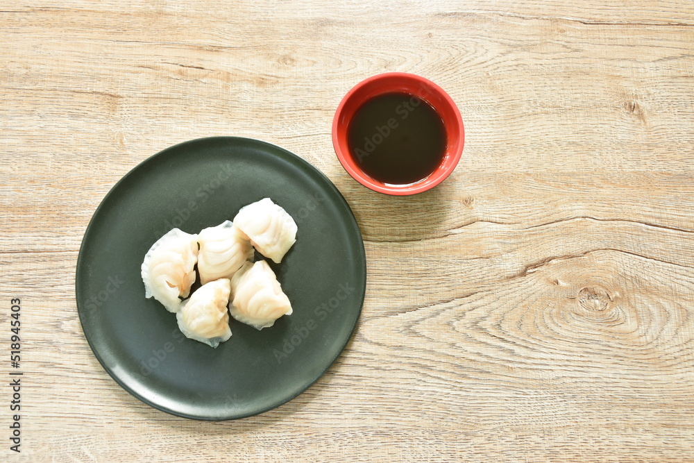 Ha Kao or white dumpling stuffed shrimp and pork on plate dipping soy sauce Ha Kao or white dumpling stuffed shrimp and pork on plate dipping soy sauce