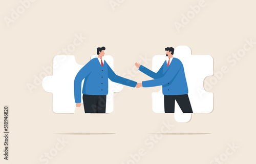 Business agreement partner or coordinating cooperation. Helping or building relationships leads to success. Businessmen handshake on jigsaw puzzle.