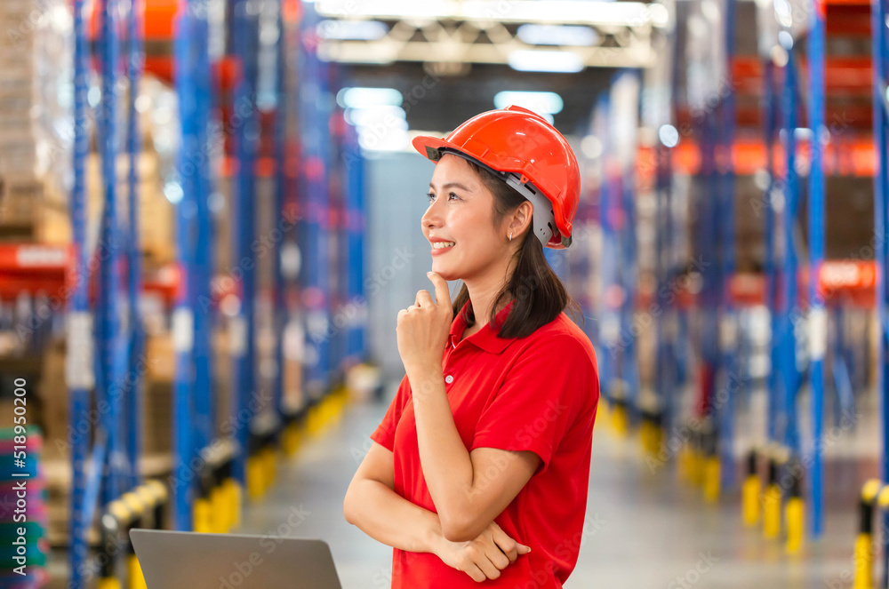 Warehouse worker working in factory warehouse industry and using laptop, Young woman thinking, Foreman working in logistics center Warehouse worker working in factory warehouse industry and using laptop, Young woman thinking, Foreman working in logistics center