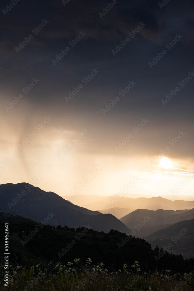 banner of mountain peaks in beautiful stormy sunset light