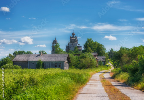 Arkhangelsk region, the village of Turchasovo near the Onega River. the old wooden Church of the Transfiguration of 1786 and the bell tower of 1793. rural road in vintage summer