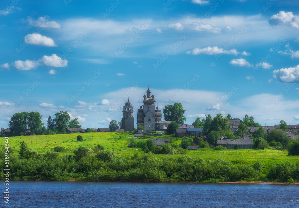 Arkhangelsk region, the village of Turchasovo near the Onega River. the old wooden Church of the Transfiguration of 1786 and the bell tower of 1793. View of ancient architecture across the river