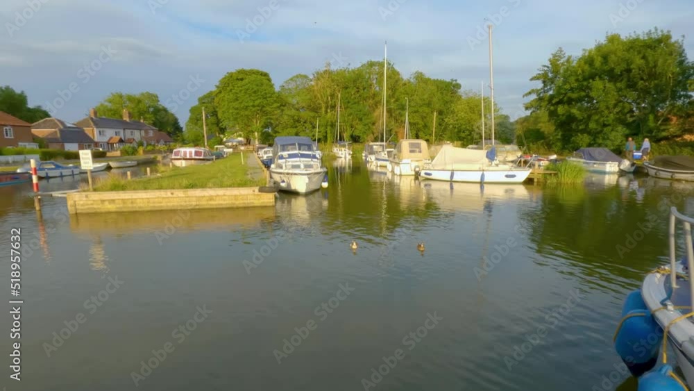 Panorama of a dyke and boatyard in the heart of the Norfolk Broads. Captured late evening as the sun is starting to get low in the sky Panorama of a dyke and boatyard in the heart of the Norfolk Broads. Captured late evening as the sun is starting to get low in the sky